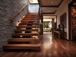 Rustic hallway featuring a wooden staircase, stone-clad wall, and a modern entrance door for a cozy home ambiance