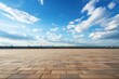 a stone floor with a blue sky and clouds