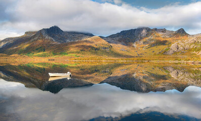 Canvas Print - wonderful mountainous landscape in Norway reflected on the water surface with a small rowboat