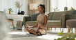 © N F/peopleimages.com - Woman, floor and yoga with lotus pose in living room, zen and meditation for mental health at home. Indian, lady and fitness for vitality in energy, exercise and chakra balance or spiritual wellness