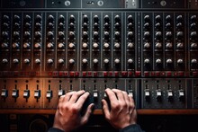 Close up of sound engineer hands working on mixing console in recording studio, Hand on a sound mixer station, top view, AI Generated