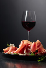 Prosciutto with rosemary and red wine.