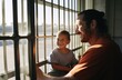 prisoners, a father and son, smile and talk in a typical prison setting