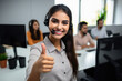 © Neha - young indian call center woman showing thumbs up.