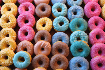 Wall Mural - Many colorful assorted donuts.