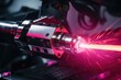 © Fotograf - A red laser being used on a machine. Can be used to illustrate precision, technology, or manufacturing processes