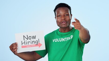 Poster - Volunteer, recruitment and face of black man with hand pointing at you in studio on blue background. Charity, donation and portrait of African male activist with ngo, poster or community service sign