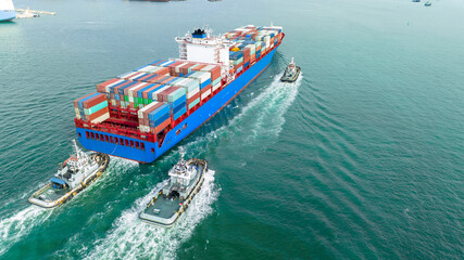 Cargo container ship carrying container and running with tug boat for import goods to cargo yard port to customs. concept logistics transportation and shipping.