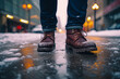 Close-up man feet in classic brown leather shoes standing on a snowy urban street, winter weather