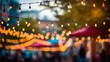 A string of decorative lights hanging in a line over a vibrant street fair. Shallow depth of field, bokeh and intentional blur.