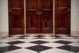 Fototapeta Big Ben - Wooden doors at the end of hall with black and white tails