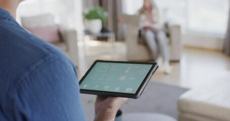 Wall Mural - middle aged caucasian man using tablet at home, copy space, slow motion