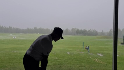 Wall Mural - Pro golf is practicing at golf driving range. Sports man plays golf and hit ball on golf course