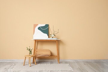 Poster - Beautiful ikebana with painting on table near beige wall in room