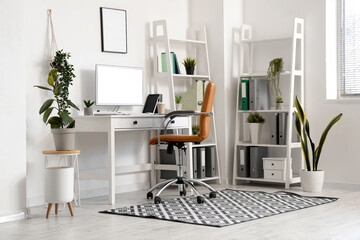 Wall Mural - Interior of office with modern workplace, shelving units and artificial plants