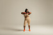 © gstockstudio - Full length happy plus size African woman in sportswear exercising