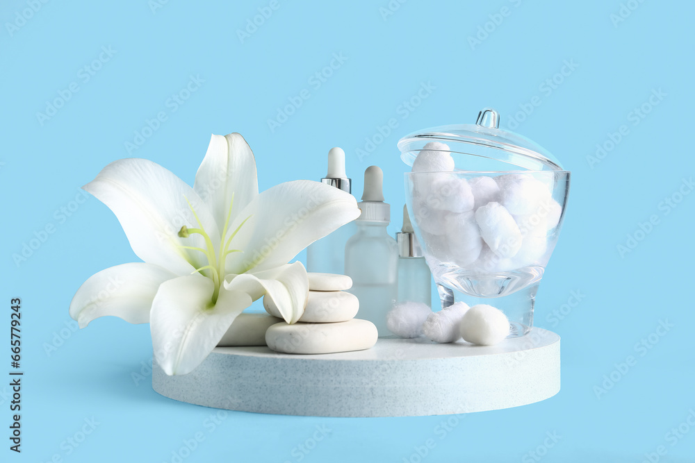 Composition with spa accessories, cosmetics and lily flower on color background