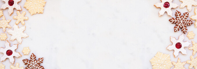 Aufkleber - Christmas baking double border with an assortment of snowflake cookies. Overhead view on a white marble banner background with copy space. Holiday baking concept.