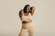 © gstockstudio - Joyful African plus size woman in underwear radiating love to her body on studio background