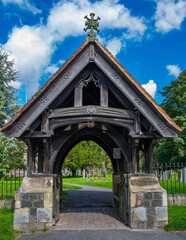 The very old wooden and stone entrance structure to a graveyard in Avebury