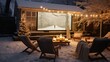 Backyard transformed into an outdoor winter cinema with a large screen and blankets.
