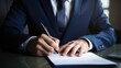 © koplesya - Businessman uses a pen to mark important things for signing a document and approving a business concept for a project.