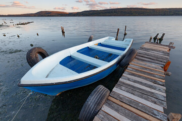 Wall Mural - exciting view of a boat at the wooden pier