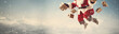 Santa Claus flies with gifts against the sky. Banner, place for text.