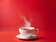 Red cup of hot coffee on red background