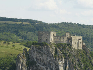 Poster - Riga, Latvia - AUGUST 20 2023.  a castle on top of a cliff in the middle of a valley.