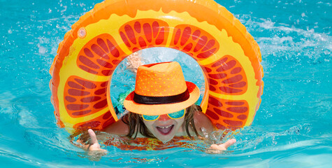 Wall Mural - Kids summer relax. Child swimming on floating ring in pool. Kid summer portrait.