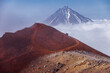 Kamchatka volcanic landscape: view to top of cone of Koryaksky Volcano from scenery active crater of Avacha Volcano on sunny day and blue sky. Russian Far East