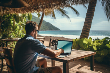 A man working on a laptop while overlooking a picturesque tropical beach, embracing the freedom of location-independent work