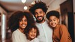 Happy smiling african american family with children posing together at home in living room