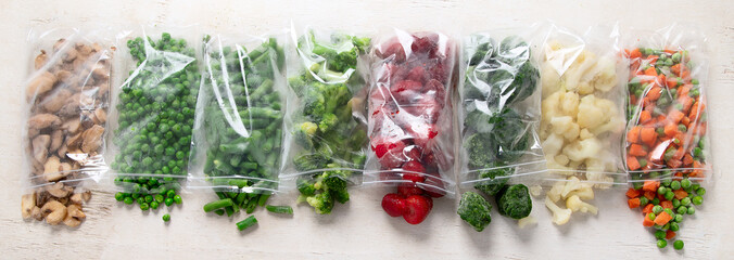 Poster - Frozen vegetable and berry fruit mix in plastic bags.