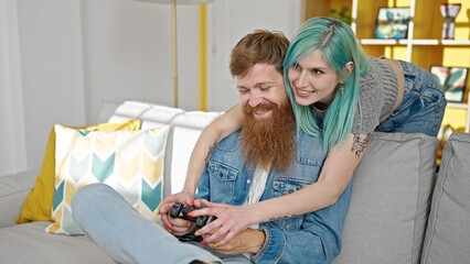 Sticker - Man and woman couple playing video game hugging at home