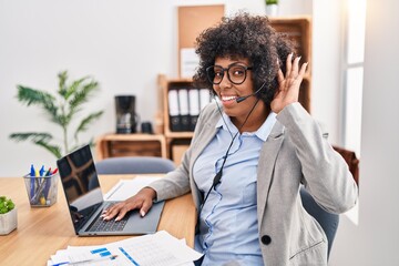 Sticker - Black woman with curly hair wearing call center agent headset at the office smiling with hand over ear listening an hearing to rumor or gossip. deafness concept.