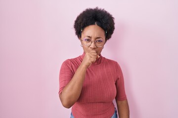 Poster - Beautiful african woman with curly hair standing over pink background feeling unwell and coughing as symptom for cold or bronchitis. health care concept.