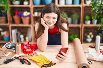 Sticker - Young caucasian woman florist smiling confident using smartphone at florist