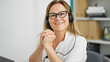 © Krakenimages.com - Middle age hispanic woman business worker using laptop and headphones smiling at the office