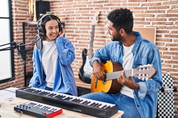 Sticker - Man and woman musicians playing classical guitar singing song at music studio