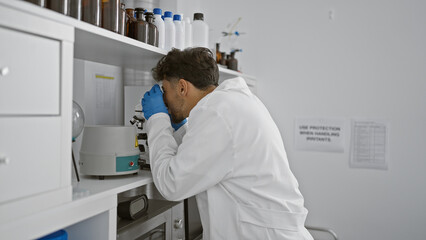 Sticker - Young arab man scientist using microscope at laboratory