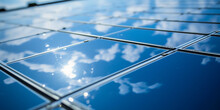 Close - Up Of Solar Panel Texture, Glossy Surface Reflecting Blue Sky And Clouds