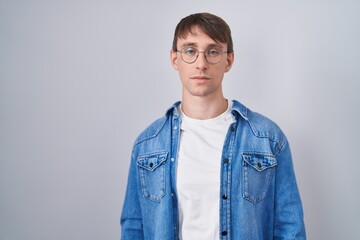 Poster - Caucasian blond man standing wearing glasses relaxed with serious expression on face. simple and natural looking at the camera.