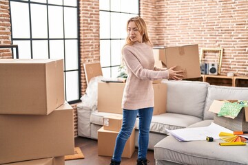 Sticker - Young woman smiling confident holding package at new home