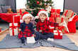 © Krakenimages.com - Adorable boy and girl drawing on paper celebrating christmas at home