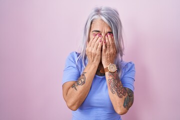 Sticker - Middle age woman with tattoos standing over pink background rubbing eyes for fatigue and headache, sleepy and tired expression. vision problem