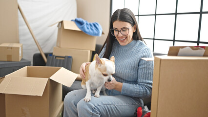 Canvas Print - Young hispanic woman with chihuahua dog playing together at new home