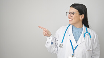 Canvas Print - Young hispanic woman doctor smiling confident pointing to the side over isolated white background