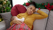 Mother and son stressed celebrating christmas breastfeeding baby at home